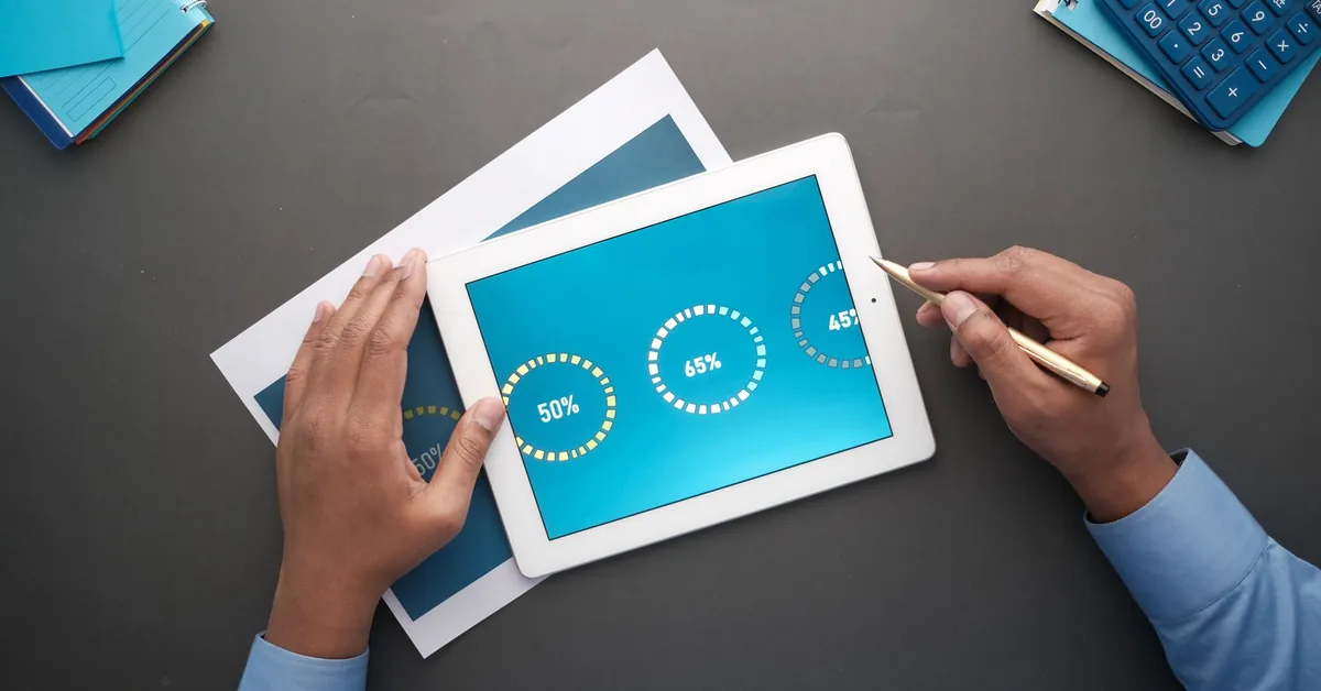 A professional reviewing statistical data on a digital tablet. Top view of business analysis. a person using a tablet
